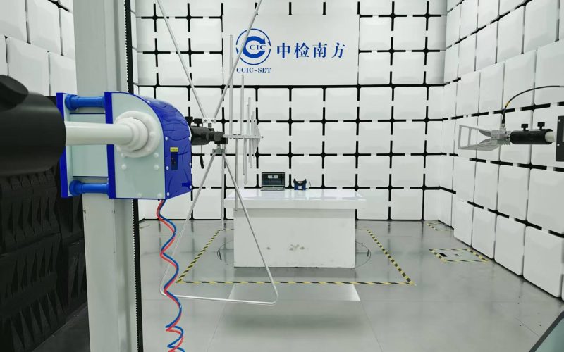 Technician testing a medical device in a soundproof room to ensure acoustic performance and precision.